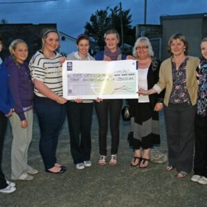 Group of people holding a cheque for 300 euro from Our Lady of Lourdes Girls to the Rape Crisis Centre