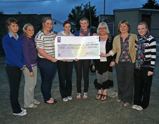 Group of people holding a cheque for 300 euro from Our Lady of Lourdes Girls to the Rape Crisis Centre