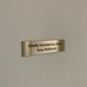 Plaque that says Kindly Donated by Artist Tony Robinson