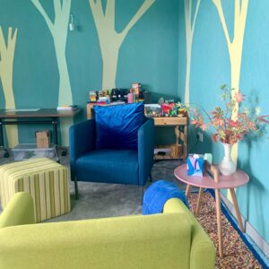 A room with a blue and white theme with 2 chairs